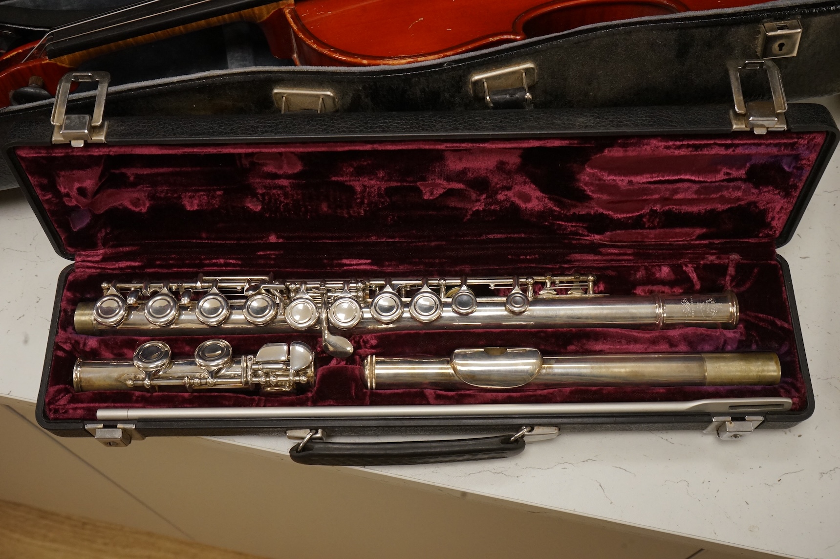 Three musical instruments to include a Buffet flute and violin with two bows